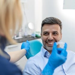 An adult orthodontic patient testing Invisalign invisible aligners